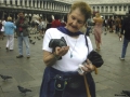 Mom feeding a pigeon in St. Mark's Square